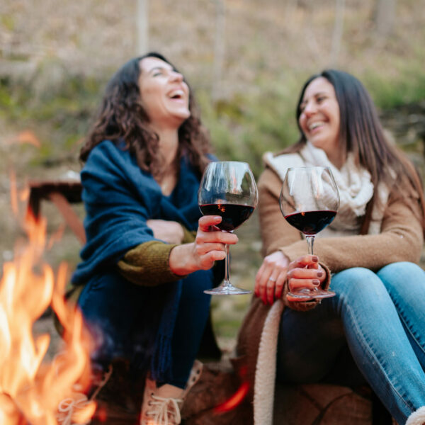 Young,Happy,Women,Laughing,,Holding,Glass,Of,Red,Wine.,Females