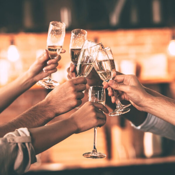 Cheers!,Group,Of,People,Cheering,With,Champagne,Flutes,With,Home